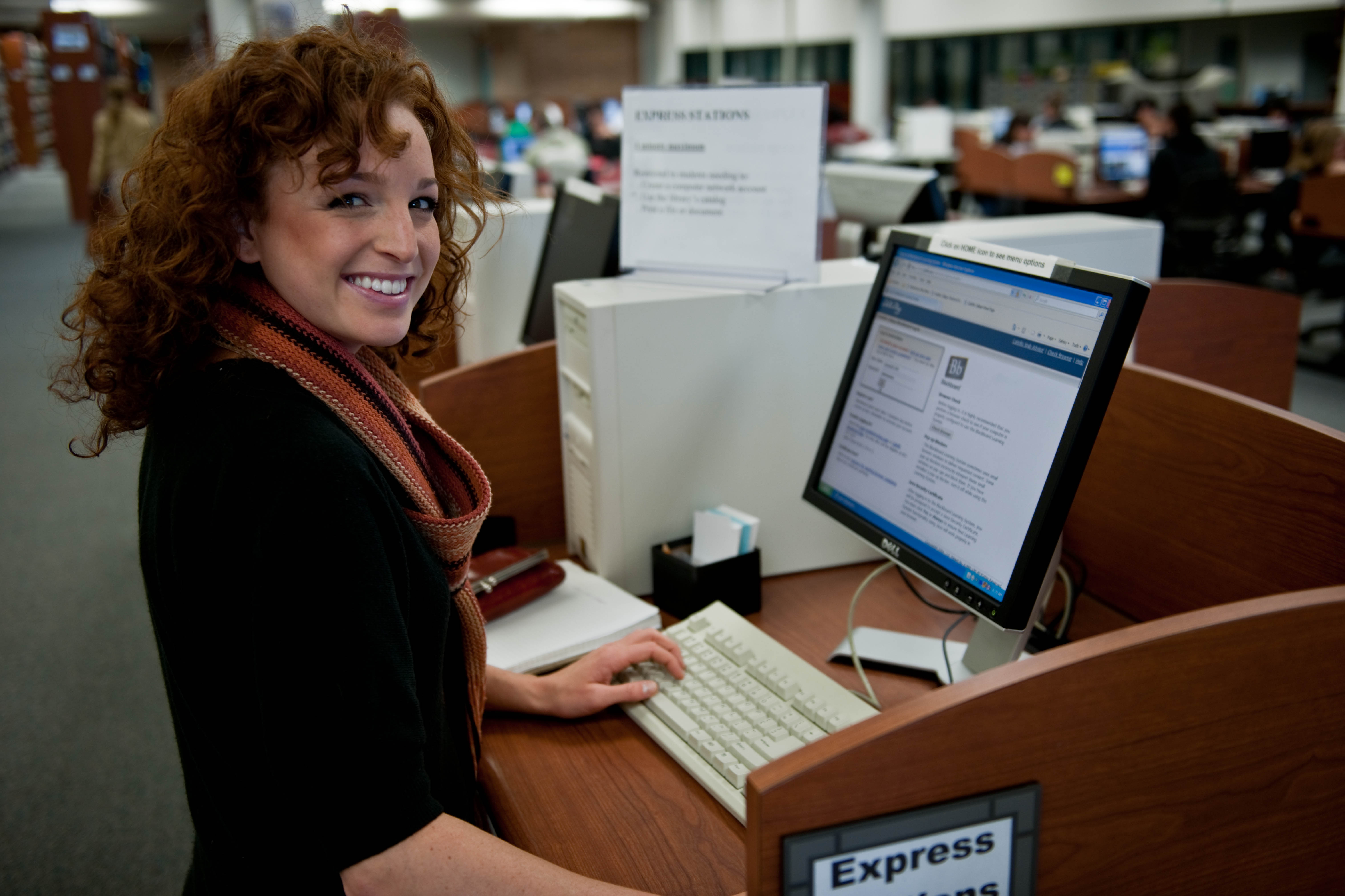 Student using an express station to print at the library